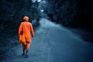 A monk or brahmachari is on his journey to attain moksha spreading the message of God along the way. The photo signifies his detachment from the society and the path he walks alone guided by the Supreme.